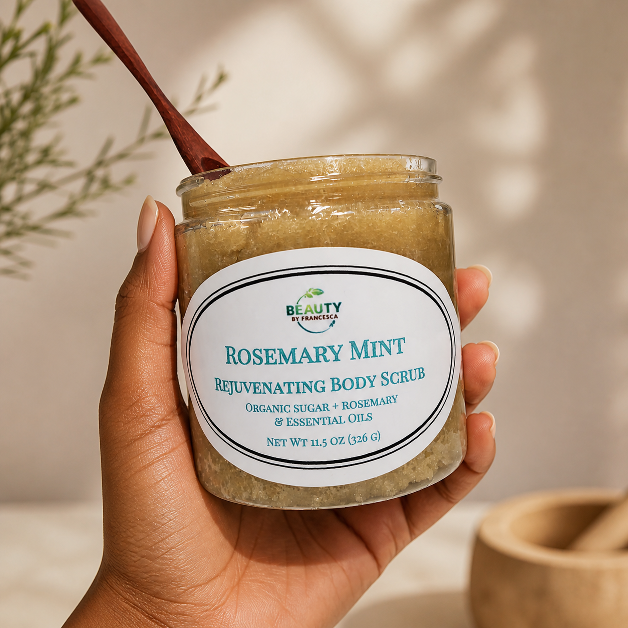 hand holding jar of rosemary mint body scrub