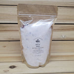 Bag of 'Royal Rose' bath salts on a wooden background