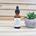 radiance facial oil next to green plant