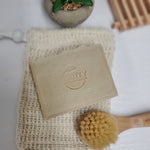 Eucalyptus Handmade Soap on reusable soap holder near tiny face brush