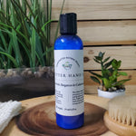 shea butter hand lotion on wood pedestal