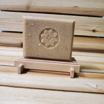 honey oatmeal chai bar soap on wood soap dish