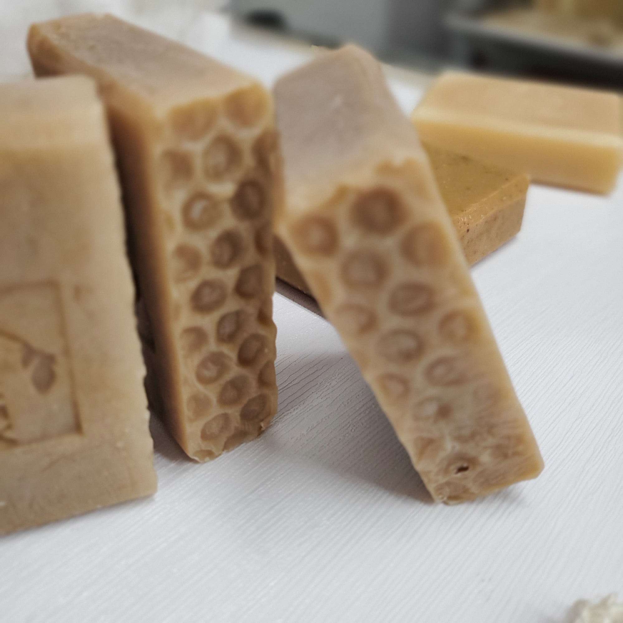 Milk and Honey handmade soap with honeycomb pattern on profile stacked upright